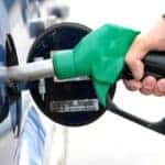 A person pumping gas into their vehicle