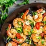 Shrimps fried on pan with fresh herbs