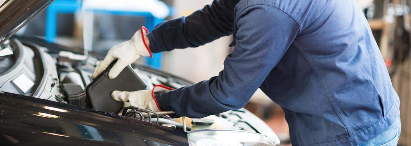Man Pouring Oil Into Car