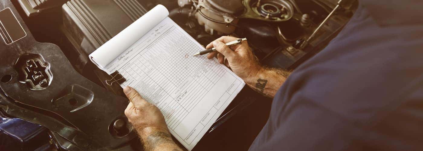 Mechanic Going Over a Checklist