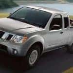 Nissan Frontier Towing a Car on Trailer