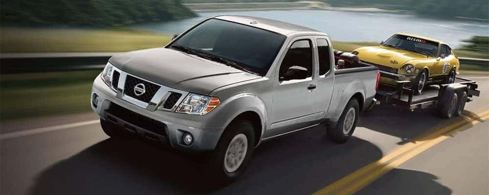 Nissan Frontier Towing a Car on Trailer