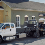 Ford F-650 with vintage car being loaded onto bed