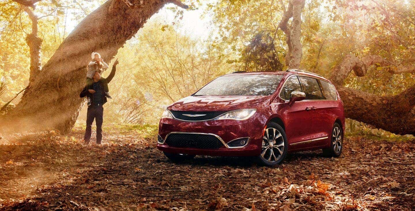 2018 Chrysler Pacifica parked in forest by a tree