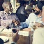 group of men out for dinner, two shaking hands