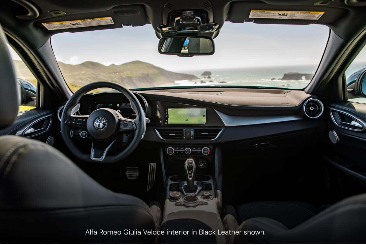 Interior view of an Alfa Romeo Giulia Veloce in Black Leather showing the dashboard and steering wheel.