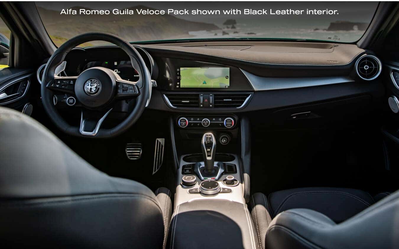 Front interior dashboard view from between the seats of a 2026 Alfa Romeo Giulia Veloce with Black Leather interior.