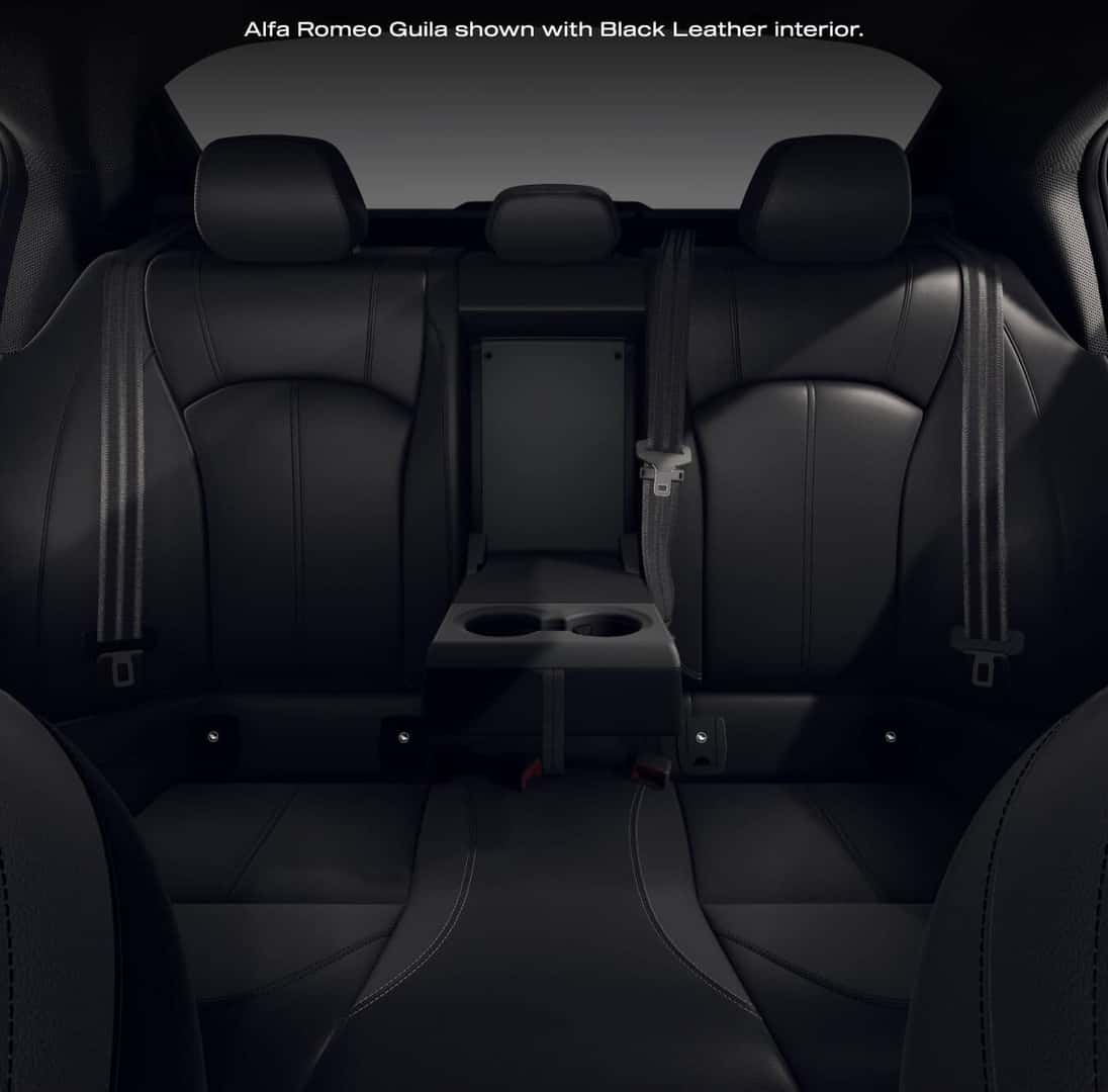 Straight-on interior view of the rear seating row in a 2026 Alfa Romeo Giulia Sprint with Black Leather interior and folded center armrest.
