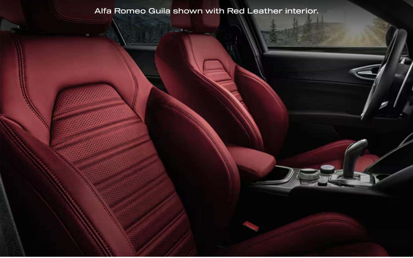 Detailed interior view of the red leather sport seats inside a 2026 Alfa Romeo Giulia with Red Leather interior.