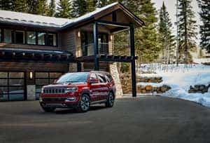 Jeep Wagoneer outside a snowy house