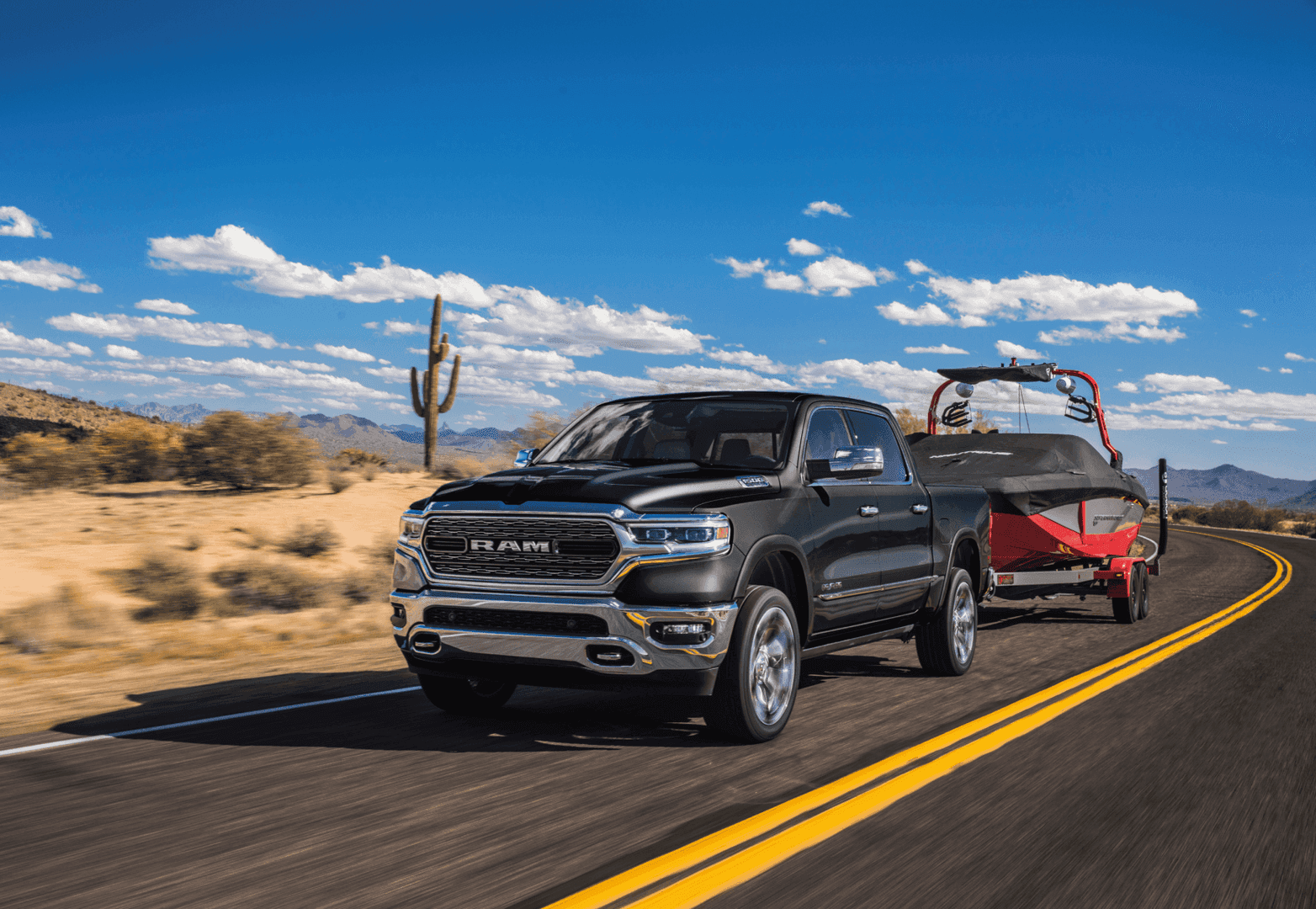 2021 Ram 1500 Black Towing Boat Highway