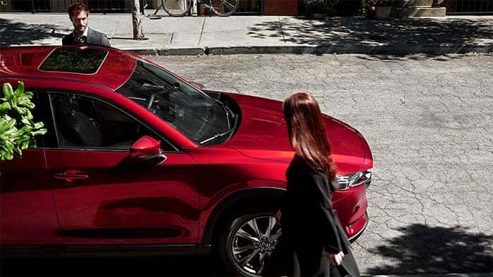 Couple walking to Mazda CX-5