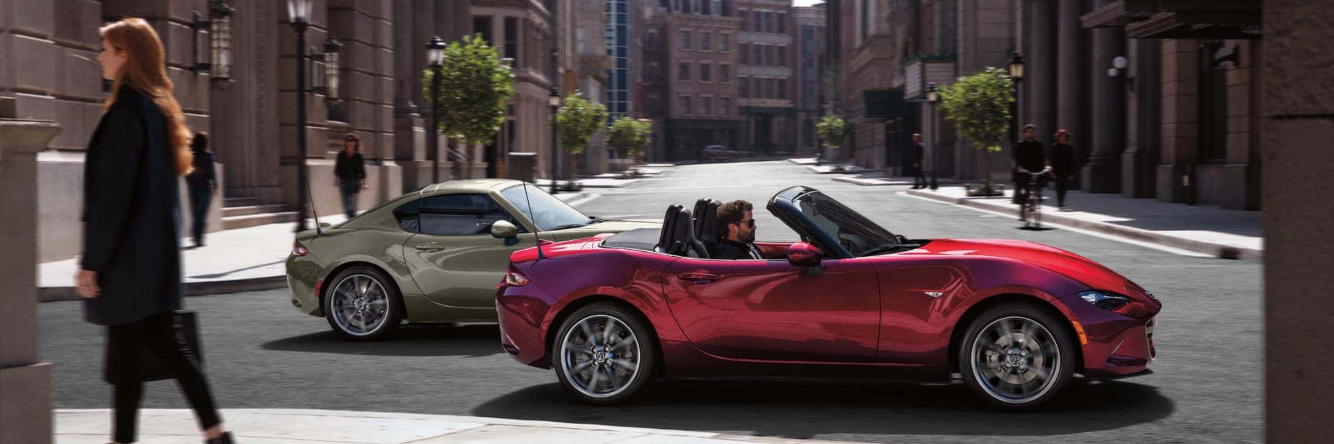 man in mazda mx5 convertible