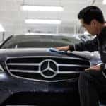 Technician detailing Mercedes-Benz car