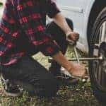 Person changing a flat tire