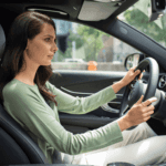 Woman driving a Mercedes-Benz and using driver assistance features
