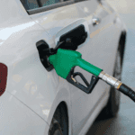 White car refueling at gas pump