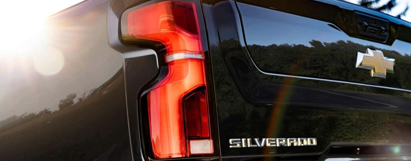 A close up shows the driver side taillight on a black 2024 Chevy Silverado 2500HD High Country.