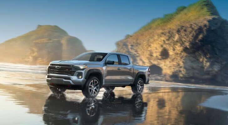 A silver 2024 Chevy Colorado Z71 driving over shallow water.