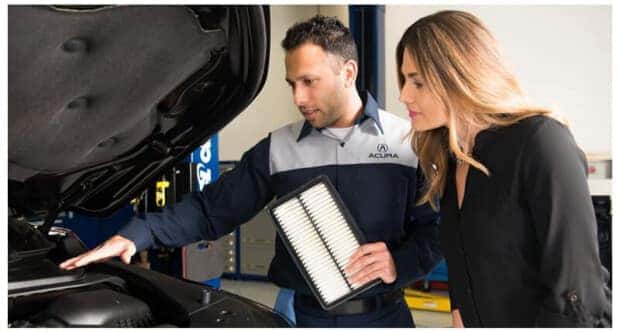 Acura service tech with customer and engine air filter