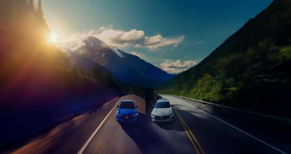 2025 Acura ADX and RDX driving through a mountain pass at sunset