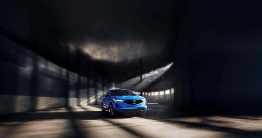 2025 Acura RDX color showing vibrantly in a dark warehouse with light streaming through the windows