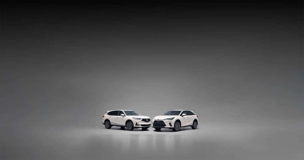 Acura MDX vs Lexus RX 350 parked in a studio with a gray backdrop