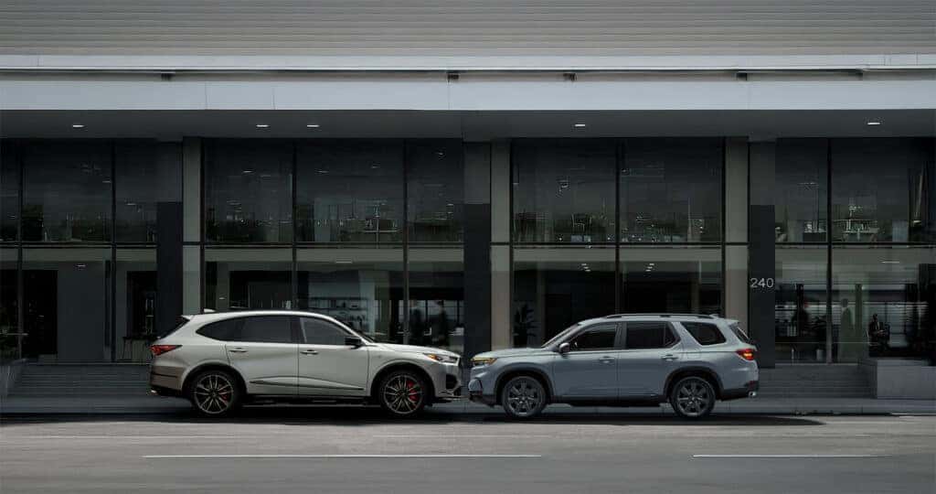 Acura MDX vs Honda Pilot parked in front of an office building downtown