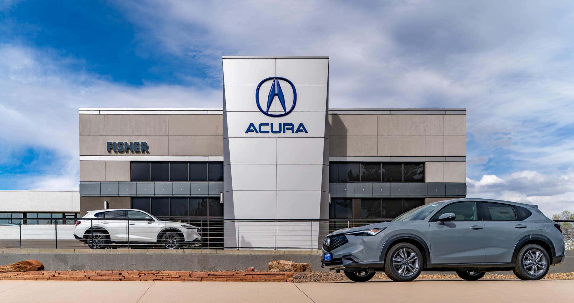 Fisher Acura Boulder Dealerships Storefront with two Acura models parked in front