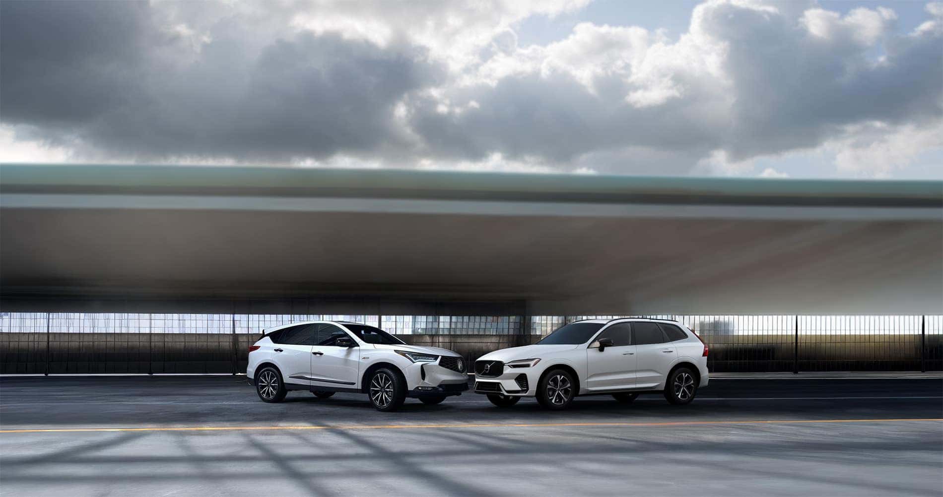 2026 Acura RDX vs Volvo XC60 parked in a warehouse