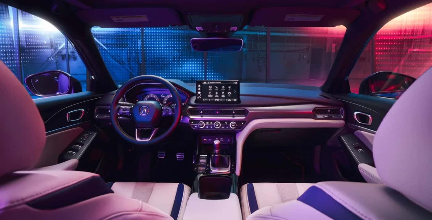 2026 Acura Integra interior featuring a driver-focused cockpit, digital display, and modern ambient lighting design