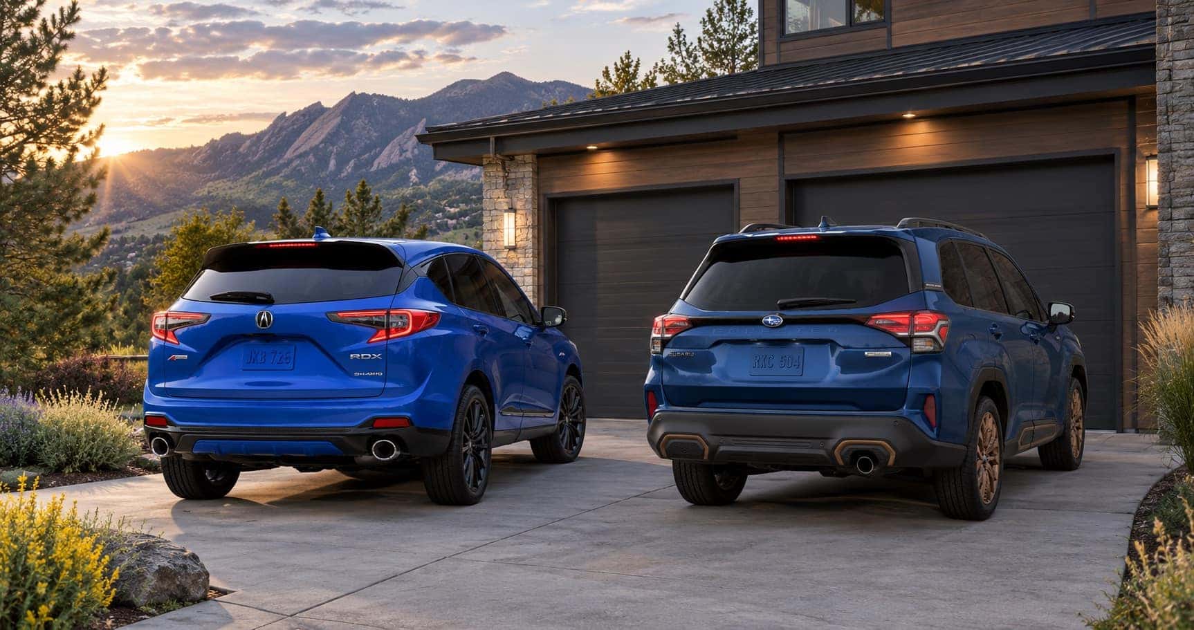 2026 Acura RDX and 2026 Subaru Forester parked in a Boulder, CO driveway with mountain views