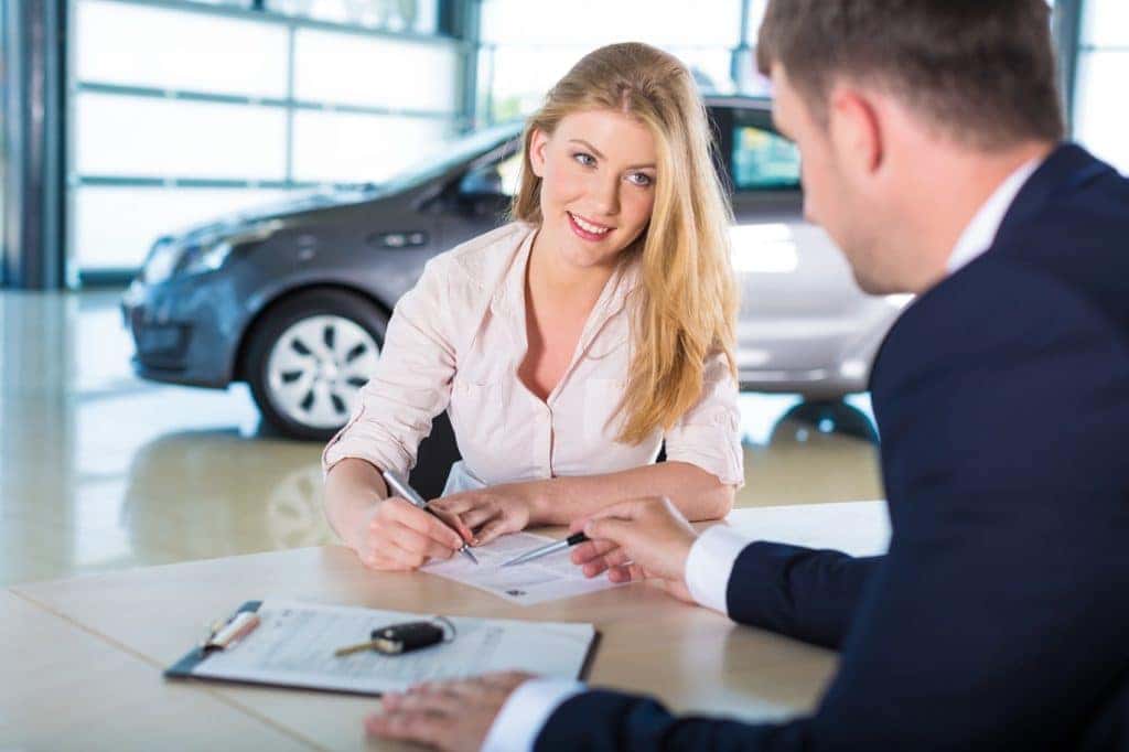 Woman talking to finance professional about loan for car