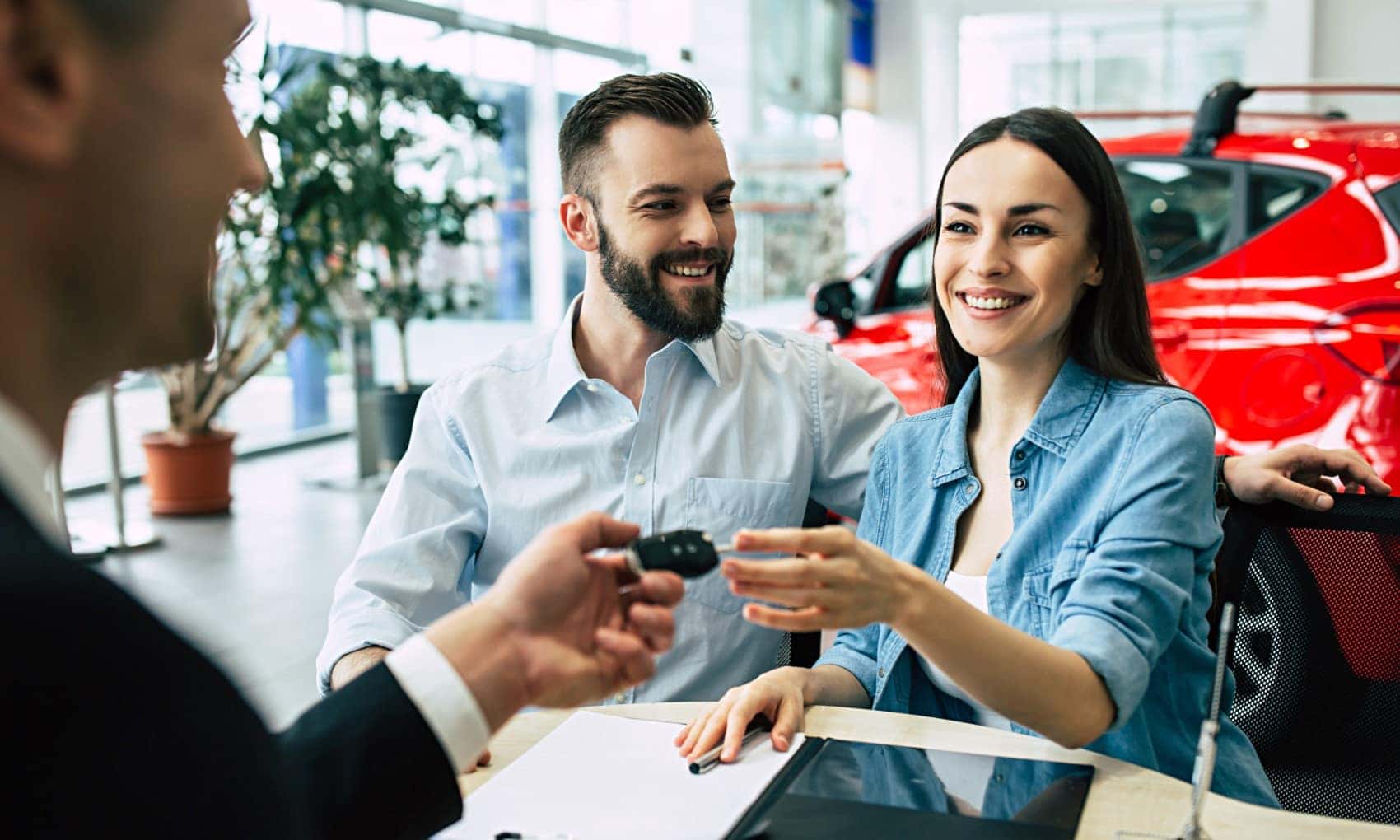 Car Salesman Handing Keys to Buyer