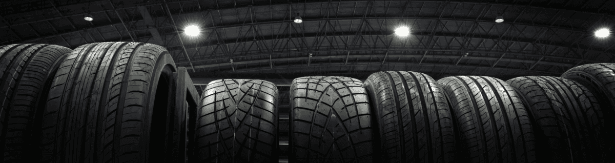 A banner of a warehouse filled with a row of tires.