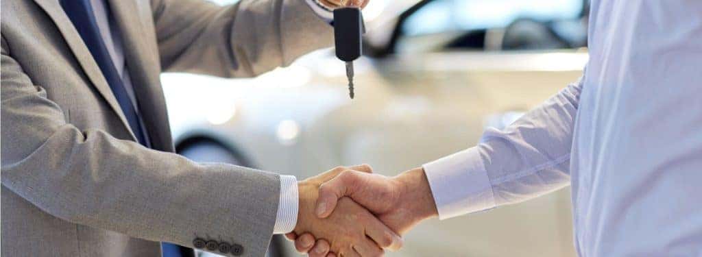 Shaking Hands on New Vehicle