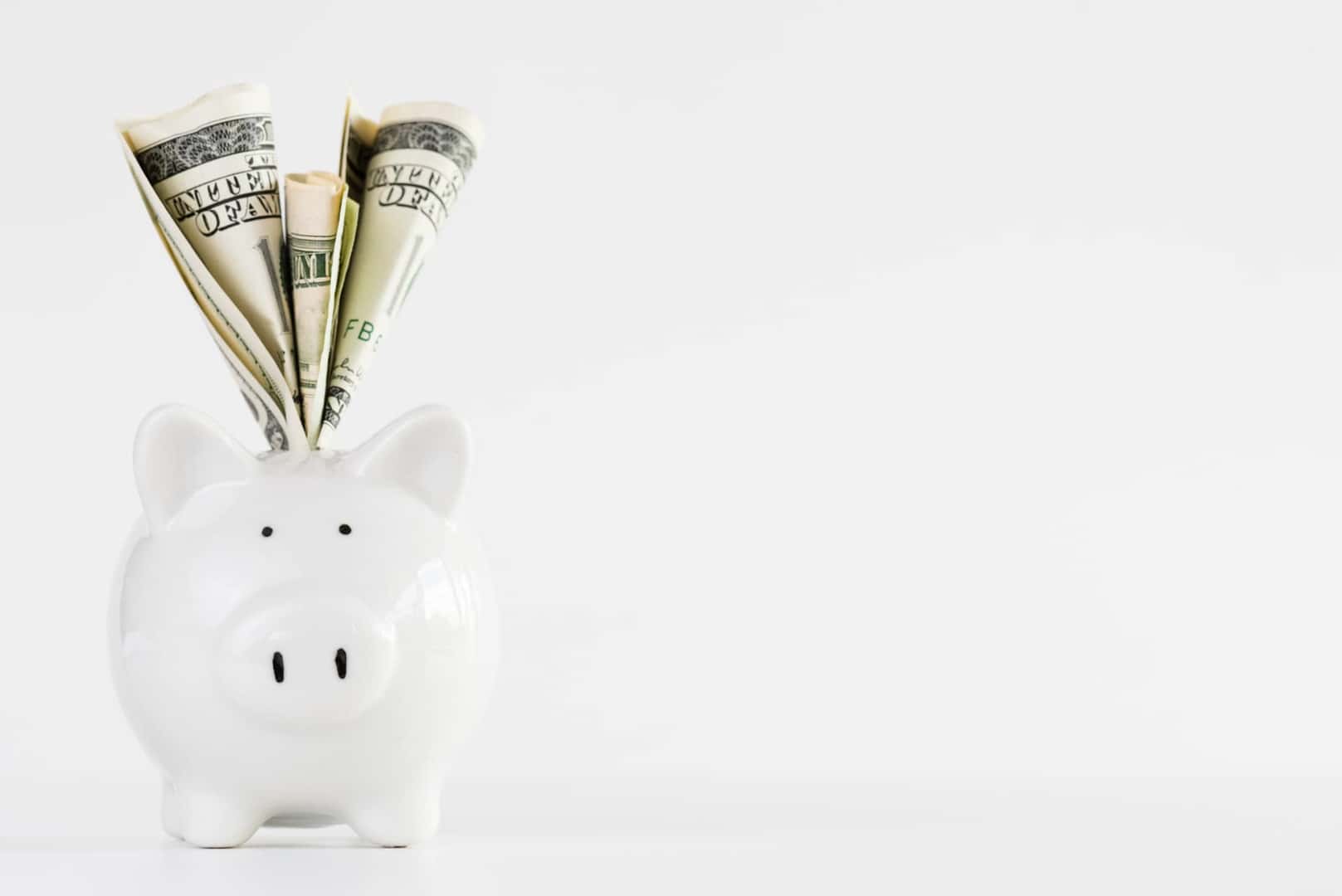 Piggy Bank with Dollar Stuffed into the top