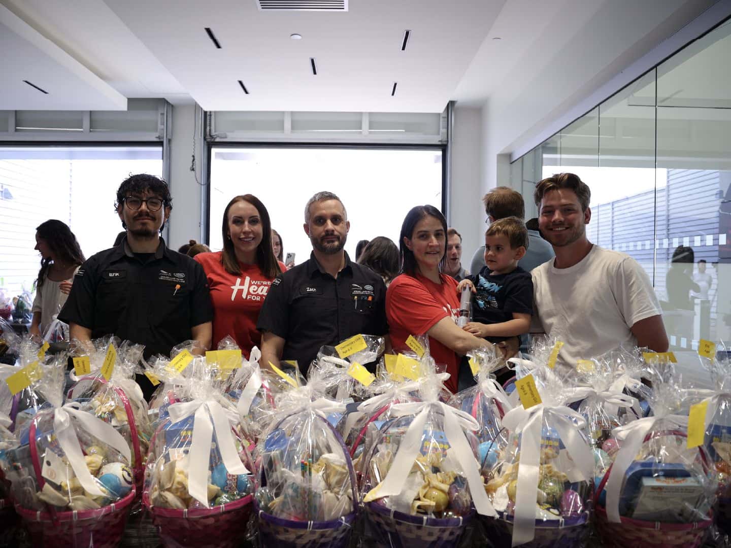 Group of people standing behind easter baskets