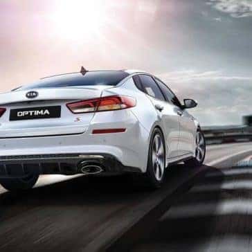 2019-Kia-Optima-rear-driving-white