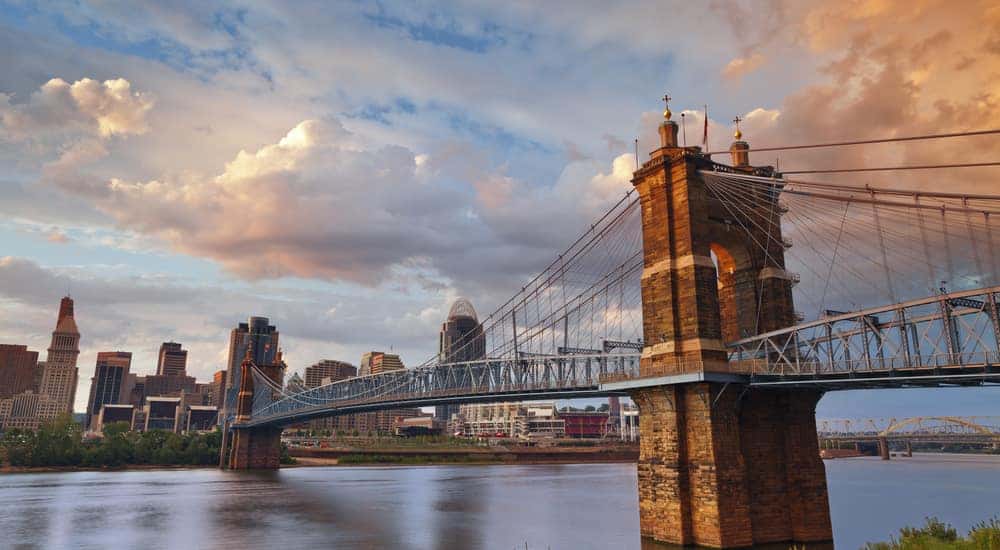 Stone bridge over water in front of tall Cincinnati Ohio