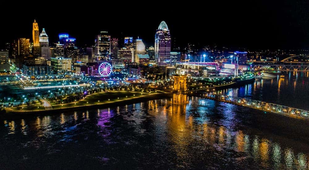 Body of water in front of the lit-up city of Cincinnati