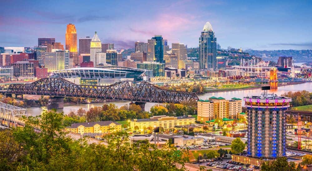 A river with a bridge going over it surrounded by tall Cincinnati, OH buildings