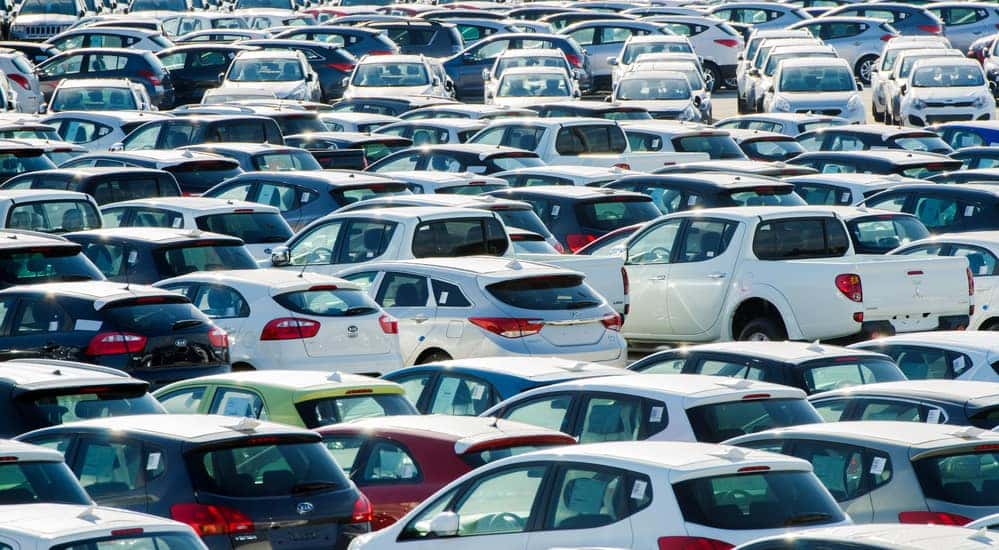 A parking lot filled with various used cars