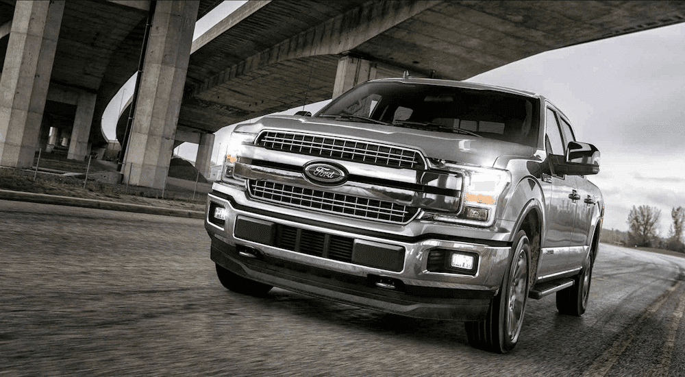 Silver 2018 Ford F150 on road under bridge