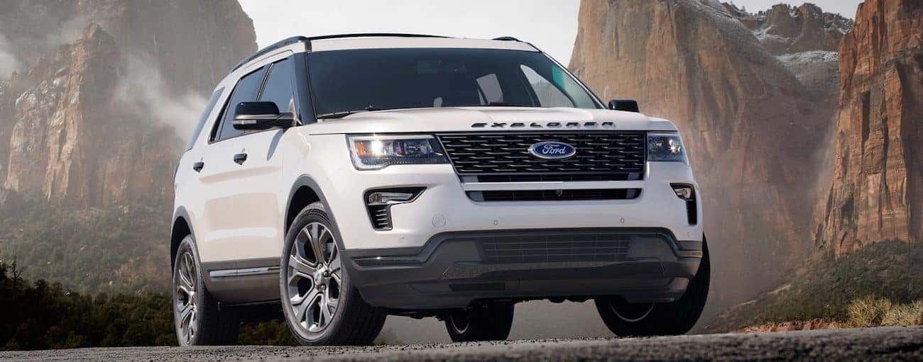 The 2019 Ford Explorer in white with rugged mountains in the background