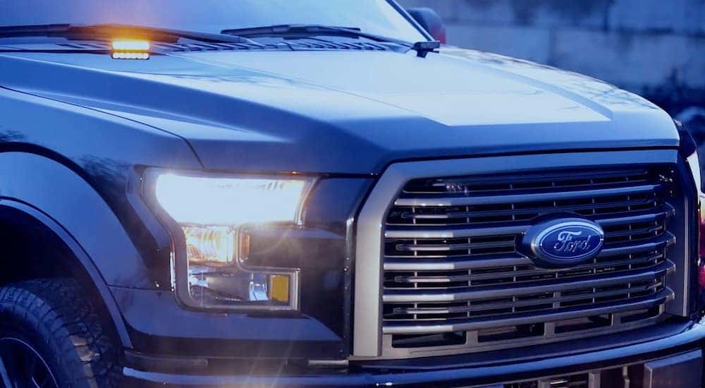 A dark blue 2016 Ford F150 closeup of the grille
