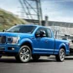A blue 2019 Ford F-150 is towing a boat.