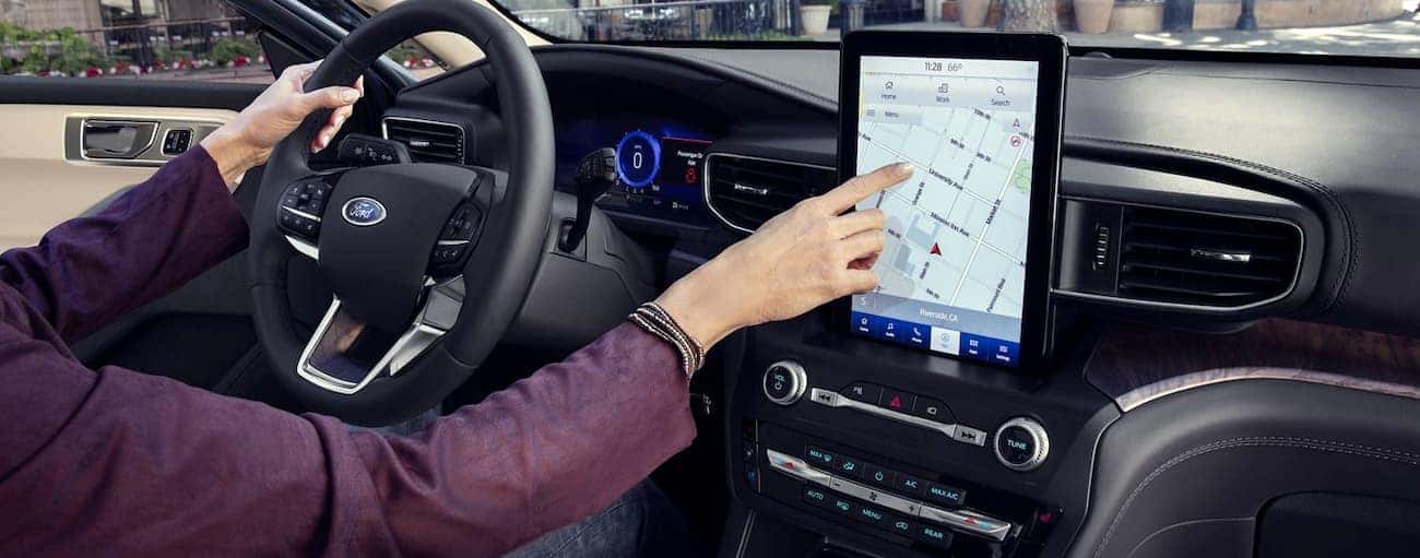 A person is using the maps feature on the touchscreen in their 2020 Ford Explorer.