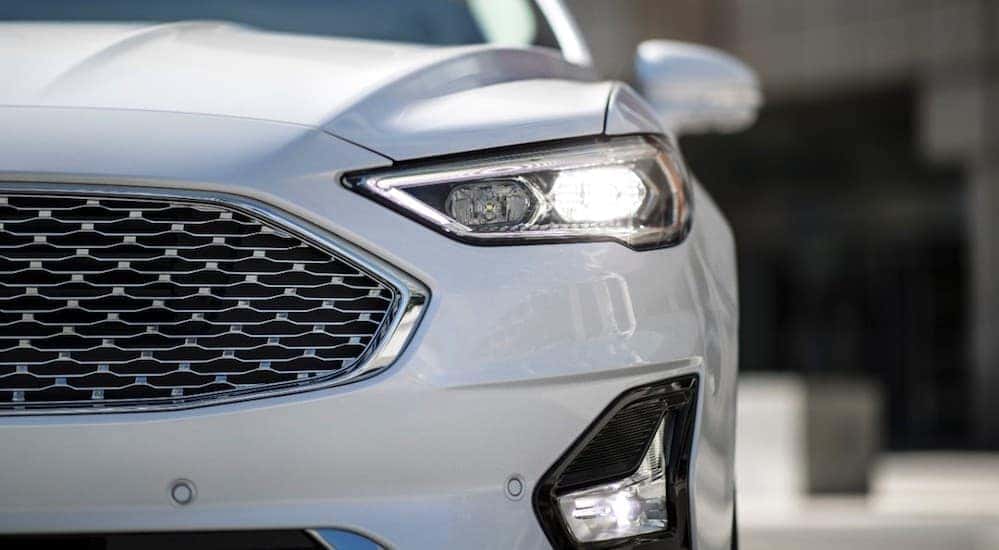 The front end of a white 2019 Ford Fusion, which is popular among Ford cars for sale, is shown.