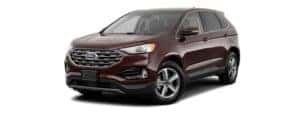 A burgundy 2019 Ford Edge is facing left.